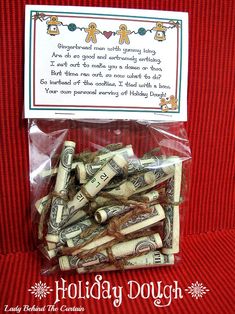 a bag filled with lots of money sitting on top of a red cloth covered table