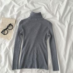 Basic ribbed knit turtleneck long sleeved shirt. Stretches to fit. One size fits S-L 27"-37" chest 21.5" length