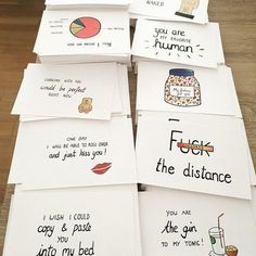 six greeting cards with different words on them sitting on top of a wooden table next to each other