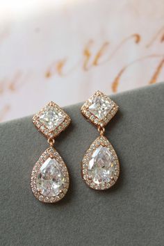 Rose gold vintage style zircon  earrings  Great for you or for your bridesmaids. Colour: rose gold /clear Stud earrings. Measurements: approx 3.5 cm, width approx  x 12mm . Materials:  rhodium over brass  components, zircon crystals. SAME STYLE in silver/blue: https://www.etsy.com/uk/listing/976619935/something-blue-wedding-earrings-for?ref=shop_home_active_1 SAME STYLE in silver/clear tone: https://www.etsy.com/uk/listing/962646758/wedding-earrings-for-brides-art-deco?ref=shop_home_active_2 Gre Wedding Rose Gold Dangle Diamond Earrings, Wedding Rose Gold Diamond Dangle Earrings, Rose Gold Elegant Diamond Earrings For Wedding, Rose Gold Dangle Diamond Earrings For Wedding, Exquisite Diamond Drop Earrings For Wedding, Classic Gold Chandelier Earrings For Anniversary, Elegant Rose Gold Chandelier Earrings For Weddings, Elegant Rose Gold Teardrop Earrings For Wedding, Elegant Rose Gold Teardrop Earrings For Anniversary