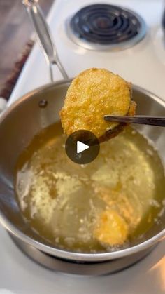 a frying pan filled with food on top of a stove next to a burner