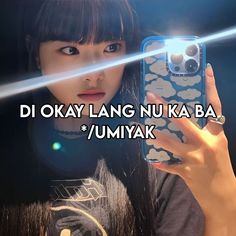 a girl holding up her cell phone with the words di okay lang nu ka ba