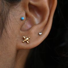 "Inspired from the beautiful Mughal motifs, this gold floral stud is a perfect piece for all your piercings. Crafted in 14k solid gold, this one of a kind pin makes for a great gift for a piercing lover and your loved ones. Great for your tragus, lobe, conch, helix, flat piercing. It also makes for a mesmerizing nose jewelry. * Dimension : 7x7mm (approx.) * Material : 14k Solid Gold If you like this stud, please press \"Pin it\" button on the top of your screen. Follow us on Instagram : @abhikaj Gold Internally Threaded Elegant Nose Studs, Elegant Tiny Yellow Gold Nose Studs, Dainty Yellow Gold Nose Studs As Gift, Dainty Yellow Gold Nose Studs For Gift, Elegant Nose Studs For Gift, Gold Dainty Tiny Nose Studs, Dainty Gold Tiny Nose Studs, Dainty Gold Nose Studs, Dainty Tiny Gold Nose Studs