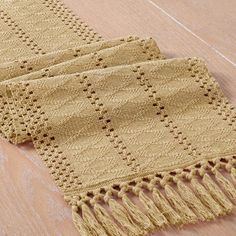 two crocheted rugs sitting on top of a wooden floor