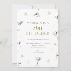 a white and gold birthday party card with martinis on it, says madison is a tiny bit older