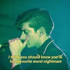 a young man singing into a microphone with a quote on the screen behind him that reads, i think you should know how you know if he has his favorite worst nightmares