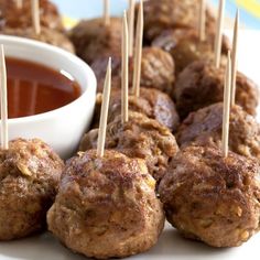 meatballs with toothpicks and dipping sauce on a plate