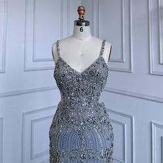 Exquisite grey mermaid gown featuring delicate spaghetti straps, perfect for weddings, parties, and formal events in 2025 . Adorned with luxurious beadwork for added glamour and sophistication. Crafted from high-quality materials for a comfortable and opulent feel. Flattering mermaid silhouette beautifully enhances the feminine figure, accentuating curves. Ideal attire for women attending weddings, gala events, evening parties, and special occasions. Inspired by luxurious Arabic fashion, exuding Arabic Fashion, Gala Events, Mermaid Silhouette, Mermaid Gown, Luxury Dress, British Indian, Pitcairn Islands, Evening Party, Mozambique