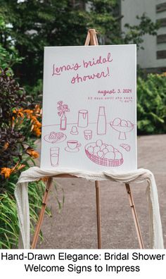 a hand - drawn bridal shower welcome sign is displayed in front of some flowers