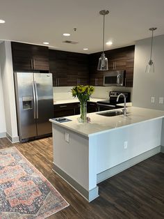 a large kitchen with an island and stainless steel appliances