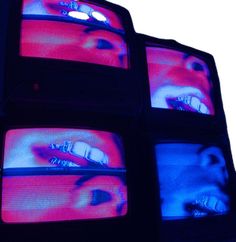 four televisions with different images on them in blue and red colors, all showing the same woman's face