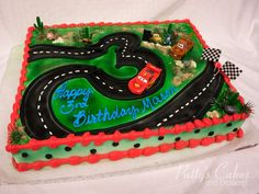 a birthday cake that is shaped like a race track