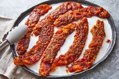 bacon strips on a plate with a spatula