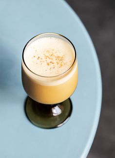 a drink sitting on top of a blue table