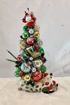 a small christmas tree with ornaments on it