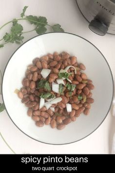 a white bowl filled with beans and onions