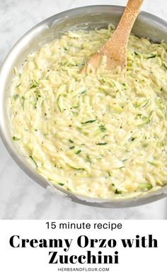 a wooden spoon in a pot filled with pasta and broccoli sauce on a marble counter top