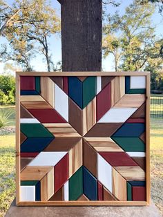 a wooden wall hanging on the side of a tree