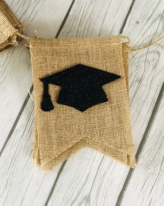 a burlap banner with a black graduation cap on it