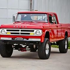 a red truck parked in front of a building