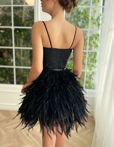 Dramatic black feathers swaddle around your body in harmony. It's intricately embellished top compliments your waist beautifully. Perfect combination of art deco and contemporary, this glamours mini dress is truly one of a kind. Cocktail Mini Dress With Ostrich Feathers, Glamorous Ostrich Feather Mini Dress For Cocktail, Black Cocktail Dresses With Ostrich Feathers, Black Ostrich Feather Cocktail Dress, Glamorous Ostrich Feather Evening Mini Dress, Evening Mini Dress With Ostrich Feathers, Chic Ostrich Feather Mini Dress For Evening, Elegant Ostrich Feather Mini Dress For Night Out, Chic Ostrich Feather Mini Dress For Party