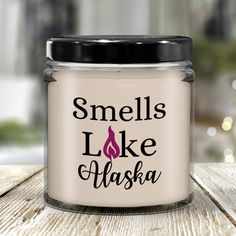 a candle that says smells like alaska on it