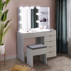 a white vanity with lights on it and a stool in front of the mirror that is open