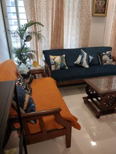 a living room with two couches and a coffee table in front of the window