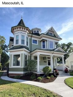 a large green and white house on the corner