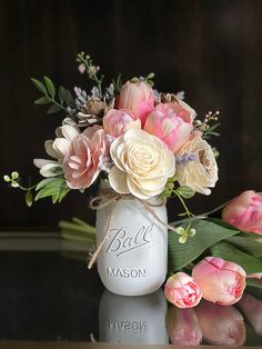 a vase filled with flowers sitting on top of a table