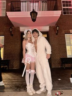 a man and woman dressed in costumes standing next to each other