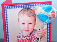 a card with a photo of a young boy holding a toothbrush in his hand