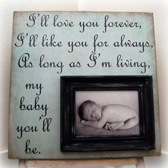 a baby is laying in a frame with the words i'll love you forever