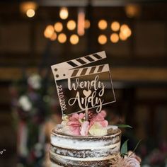 a wedding cake with a sign on top