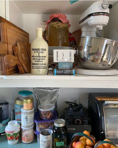 the shelves are full of food and condiments, including an electric blender