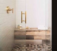 a bathroom with a walk in shower next to a tiled floor