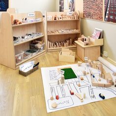 a child's playroom with wooden toys on the floor