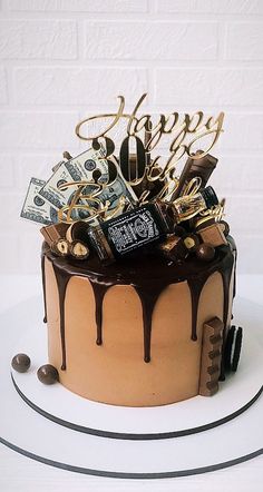 a birthday cake with chocolate icing and money on top