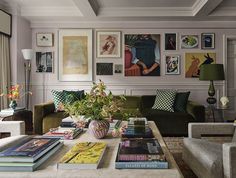 a living room filled with lots of furniture and pictures on the wall above it's coffee table