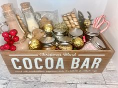 a wooden box filled with lots of different types of christmas treats and candy canes