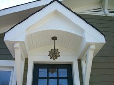 the front door of a house with a star decoration hanging from it's side