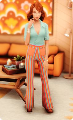 a woman standing in front of a couch wearing colorful pants and a blue shirt with stripes on it