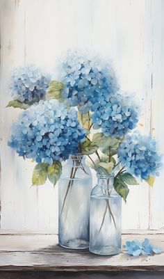 two vases filled with blue flowers on top of a table