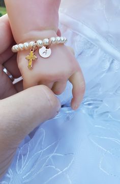 "Baby Baptism Bracelet/ Toddler Pearl Bracelet/ Infant Cross Bracelet/ Baptism Jewelry Precious, dainty little bracelet is beaded with 4 mm Cream Colored Swarovski Pearls Bracelet is adorned with tiny 13x7mm Rose Gold finished cross This bracelet is personalized with 7mm Genuine 14 K Rose Gold Filled disc charm with initial of choosing stamped on charm. Bracelet comes with adjustable slide clasp. The clasp simply slides up or down the chain to tighten or loosen the bracelet. This makes gift givi Adjustable Gold Rosary Bracelet For Baptism, Personalized Gold Rosary Bracelet For Baptism, Adjustable Personalized Pearl Bracelet For Baptism, Personalized Adjustable Rosary Bracelet For Confirmation, Baptism Bracelet, Swarovski Pearls Bracelet, Toddler Bracelet, K Rose, Goddaughter Gifts