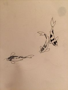 two black and white koi fish swimming next to each other on a sheet of paper