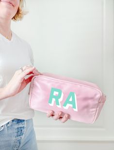 "You can never have too many monogrammed bags! The sweetest pink nylon zipper bag is perfect to carry your lipglosses, sunglasses, vitamins, essential oils. Use it to store and carry makeup, a coin purse, school supplies and more! We love these for birthday gifts and bachelorette party gifts and bridesmaid gift.  A great cosmetic bag for travel, makeup artists, teens, and school organization. D E T A I L S * 10\" x 5\" x 3\"  * 3\" gusseted bottom F A B R I C  * nylon * wipeable interior and ext Personalized Zipper Pouch Cosmetic Bag, Customizable Everyday Rectangular Cosmetic Bag, Customizable Rectangular Cosmetic Bag, Personalized Pouch Cosmetic Bag For Daily Use, Personalized Pouch Cosmetic Bag, Personalized Cosmetic Pouch Bag, Custom Name Pink Travel Bag, Personalized Rectangular Travel Cosmetic Bag, Monogram Cosmetic Bag