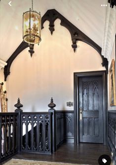 an ornately decorated entry way with black doors and railings on either side of the door