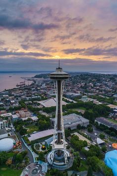 an aerial view of the space needle in seattle, usa at sunset or dawn with colorful clouds