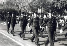 men in uniform marching down the street