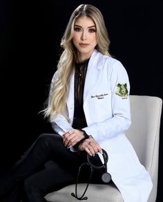 a woman in a white coat sitting on a chair with a stethoscope